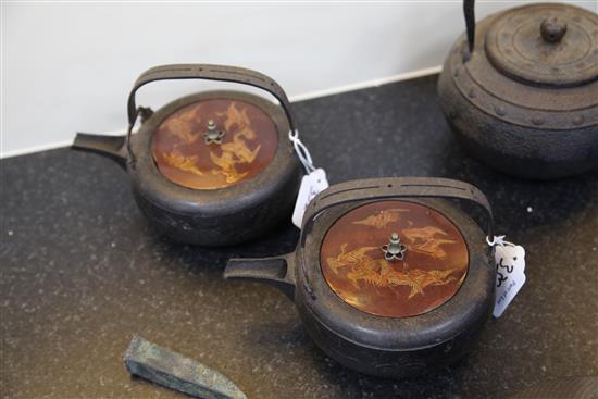 Five Japanese cast iron teapots, two with lacquer covers, 19th century, largest 19cm wide